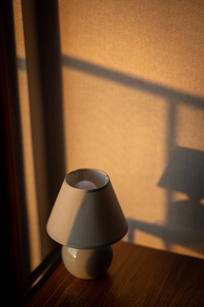 istock Morning sunlight with stylish table lamp at the wooden table 1511664076