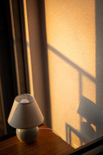 istock Morning sunlight with stylish table lamp at the wooden table 1511664077
