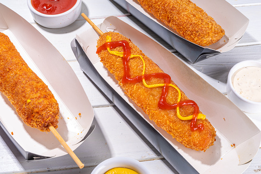 Traditional american, mexican corn dog with sauces - ketchup, mayo, mustard