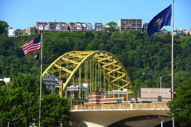 View of Fort Pitt Bridge and sign for Fort Pitt Tunnel with residences on Mount Washington in the background