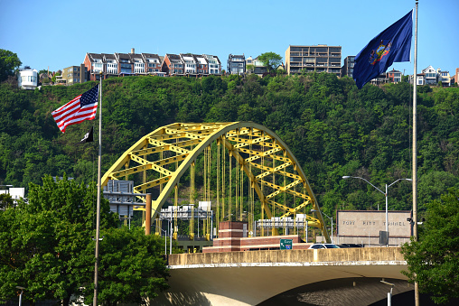 View of Fort Pitt Bridge and sign for Fort Pitt Tunnel with residences on Mount Washington in the background