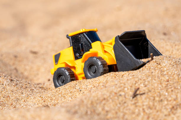 istock A toy excavator on the sand beach 1511686187