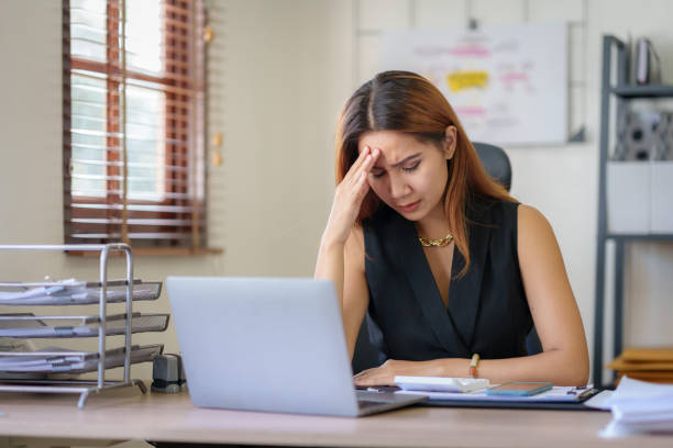 istock Asian businesswoman feeling stressed at work when faced with difficult tasks and unresolved problems. Feeling exhausted from stress while working at the office. 1511690330