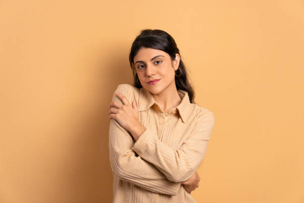 istock young woman embracing self, hugging 1511704960