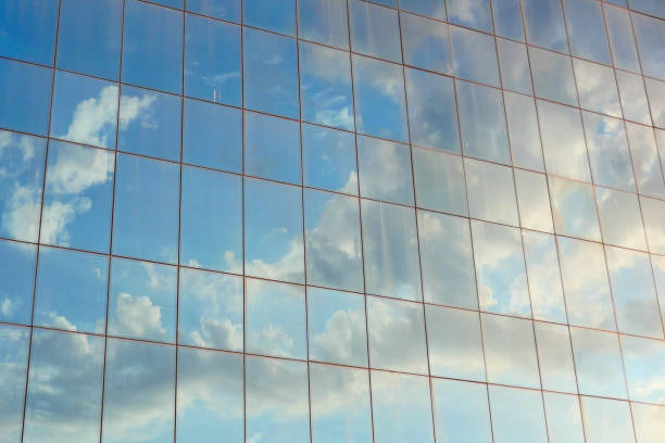 istock blue sky reflecting on modern city glass buildings 1511726342