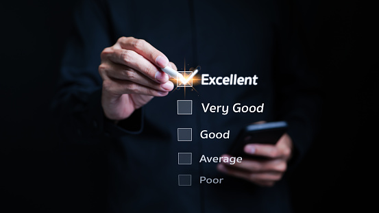 User give excellent ratings and check mark on a checklist. online survey, Customer review satisfaction feedback survey concept. Client evaluate quality of service reputation ranking of business.