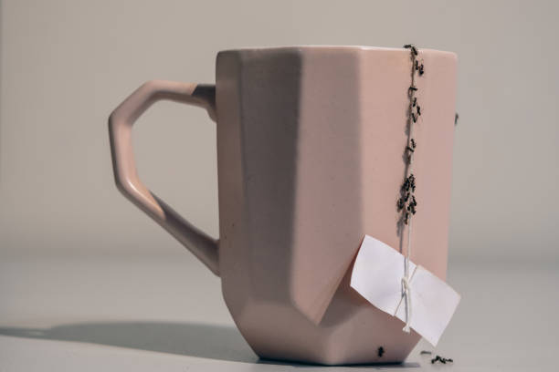 istock Ants in the house - falling on a pink mug 1511737479