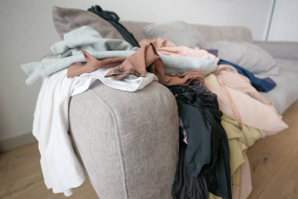 istock Messy clothes on sofa at home 1511748316