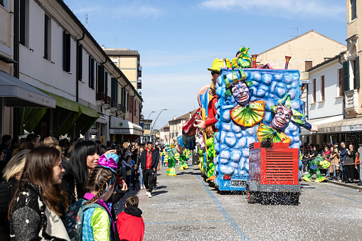 Piove di Sacco, Veneto, Italy - Mar 26th, 2023: Crowd of people watching a parade during a Carnival party