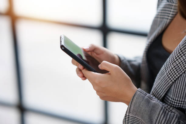 istock Close-up of a woman using a smartphone to work on various application including mobile transaction to send messages, LINE, and various business information sent via social media. 1511758765