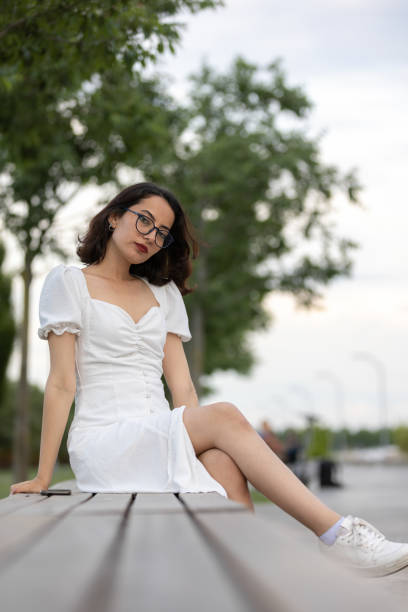 istock Young woman is sittin on park bench. 1511768994