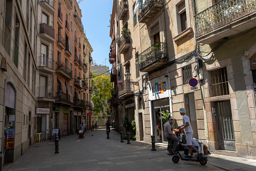 Barcelona, Spain - June 22, 2023: Narrow winding street in Barrio Gotico (Gothic Quarter) in Barcelona, Catalonia, Spain.
