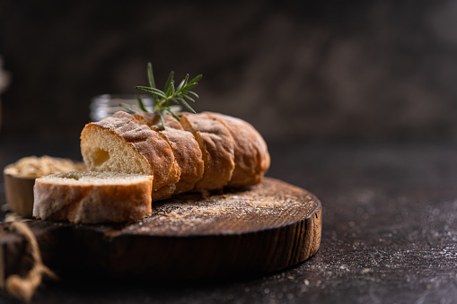 Fresh homemade artisan loaf of baguette breads on rustic background with copy space. sourdough mini baguette breads.