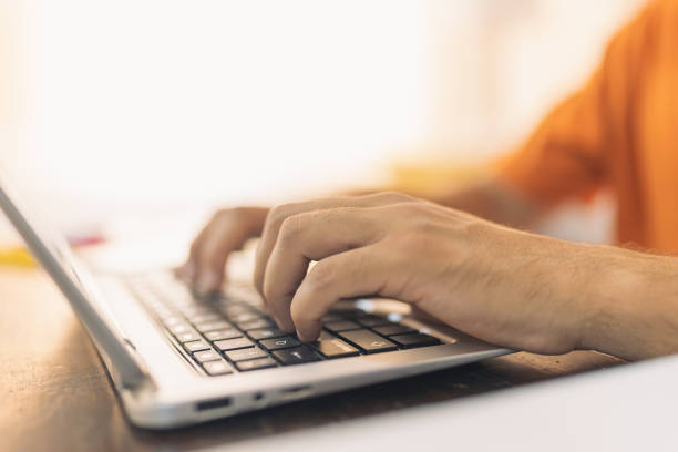 istock Hands of a man using a laptop at home 1511813106
