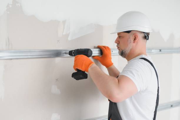 istock man fasten metal profile frame to the wall for draywall bulkhead. 1511844996