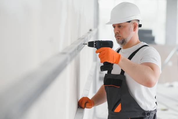 istock man fasten metal profile frame to the wall for draywall bulkhead. 1511844997