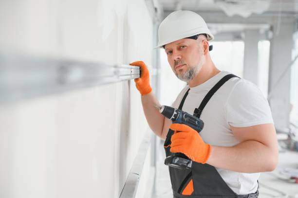 istock man fasten metal profile frame to the wall for draywall bulkhead. 1511852534