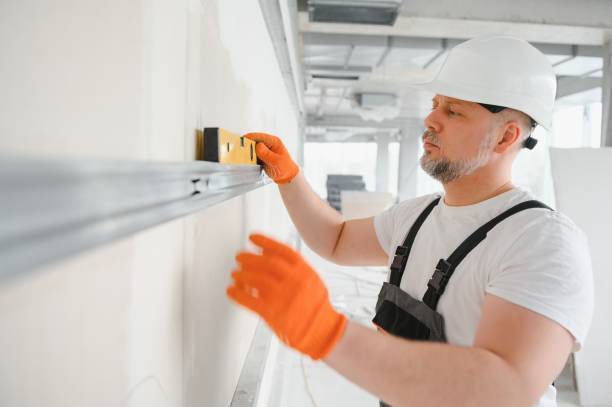 istock man fasten metal profile frame to the wall for draywall bulkhead. 1511854604