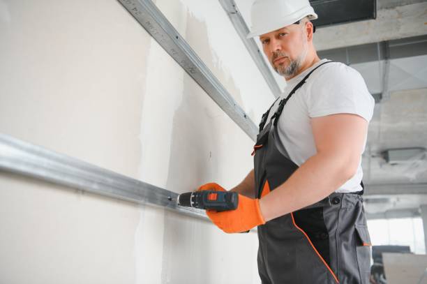 istock man drywall worker installing plasterboard sheet to wall 1511854605