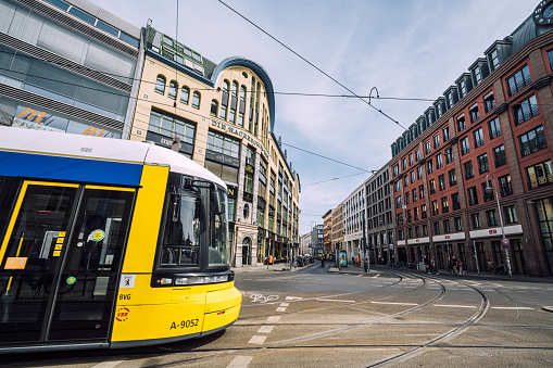 Vibrant yellow tram at Hackescher Markt, Berlin: Iconic transportation in historic city