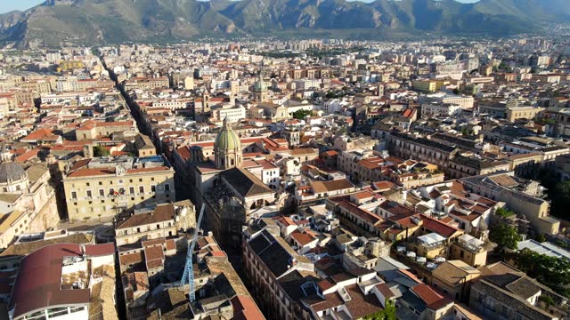 Aerial shot drone orbits to the right around intersection of Via Maqueda and Via Vittorio Emmanuele in Palermo, Sicily, Italy