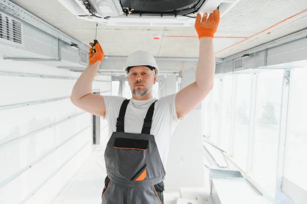 istock Worker repairing ceiling air conditioning unit 1511867473