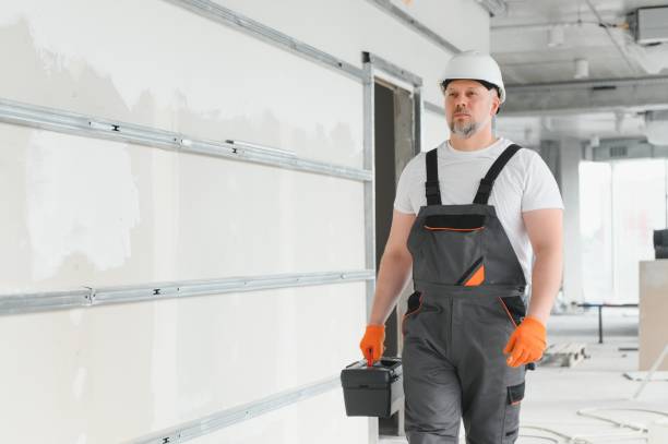 istock Man Builder. Architect is standing in building. Portrait of thinking builder. Builder architect in unfinished building. Architect in working uniform. 1511869154