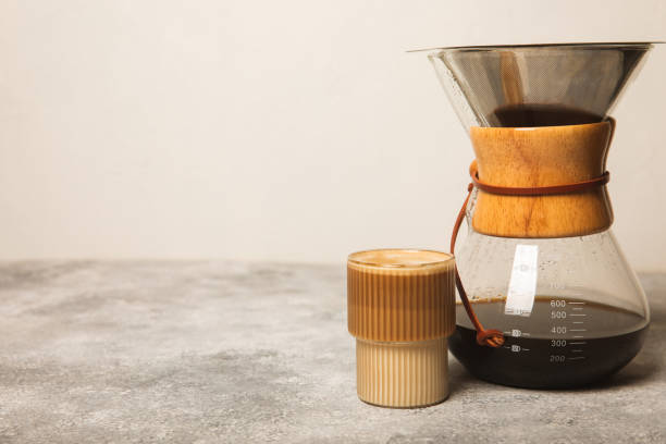 istock Preparing coffee using Chemex, pour coffee maker and drip kettle. Alternative ways to brew coffee.Coffee shop concept.Creamy latte with cream. Vanilla raf. 1511908984