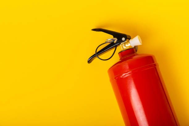 istock Fire extinguisher on a yellow background. Fire protection, home fire extinguisher. home security concept. Place for text. Copy space. 1511917041