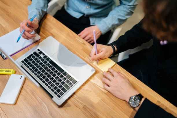 istock Close-up high-angle view of unrecognizable businessman making notes during boardroom meeting sitting at desk with laptop. Business job offer, financial success 1511933755