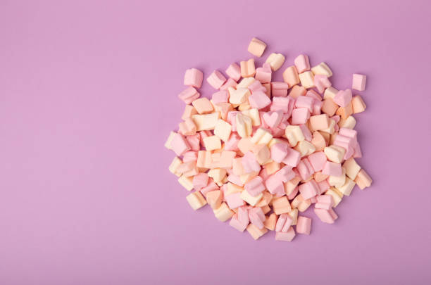 istock Zephyr in a glass jar on a lilac background. Fruit flavored sweets. Strawberry marshmallow.Copy space. Place for text 1511934495