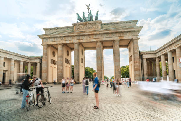 istock Dynamic People, Brandenburg Gate, Berlin, daytime, bustling city, blurred motion, lively atmosphere. 1511934689