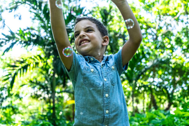 istock Little boy playing with bubbles at a park 1511934853