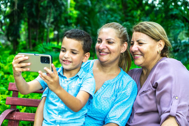 istock Family using mobile phone on a public park 1511934895