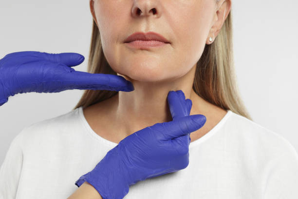istock Endocrinologist examining thyroid gland of patient on light grey background, closeup 1511949109