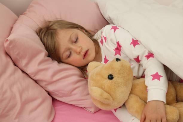 istock Little girl snoring while sleeping in bed 1511949766