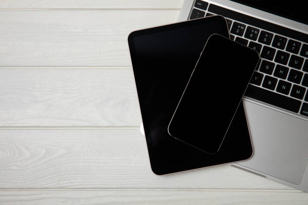 istock Open laptop with digital tablet and smartphone on the office table. Office workplace with text space. top view, flatley. MOCAP. Technology concept. 1511990809