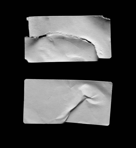 istock White torn and crumpled stickers on a black background 1511996718
