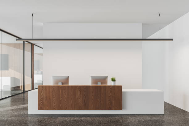istock Stylish reception interior desk with two computers and business office hallway 1512004184