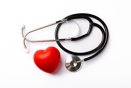 Black stethoscope and red heart isolated on white background, close up. Healthcare. Place for text. Medicine concept. The concept of cardiology.