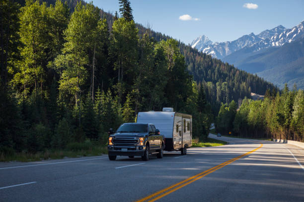 Pickup Truck and Camping Trailer on the Trans-Canada Highway in the Canadian Rocky Mountains of Banff National Park in Alberta, Canada stock photo