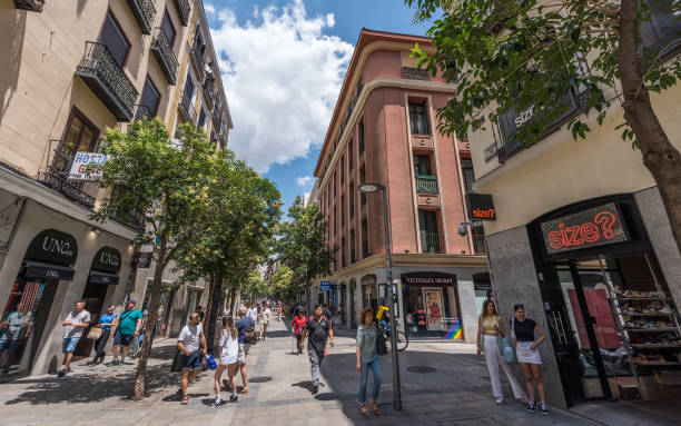 Madrid, Spain - June 22, 2023: People shopping at Fuencarral street in Madrid. Calle de Fuencarral is a street in the center of downtown Madrid. It is a popular shopping street and tourist area. The street is noteworthy for being the fourth most expensive street to live on in Madrid.