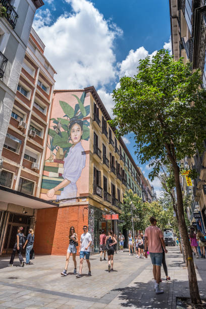 Madrid, Spain - June 22, 2023: People shopping at Fuencarral street in Madrid. Calle de Fuencarral is a street in the center of downtown Madrid. It is a popular shopping street and tourist area. The street is noteworthy for being the fourth most expensive street to live on in Madrid.