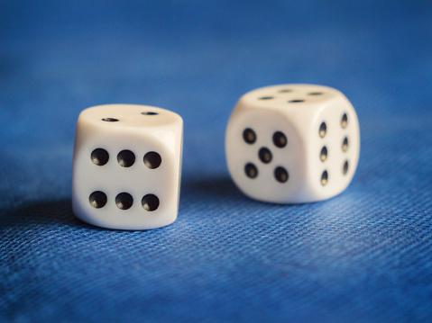 Two White Dice on Blue Background