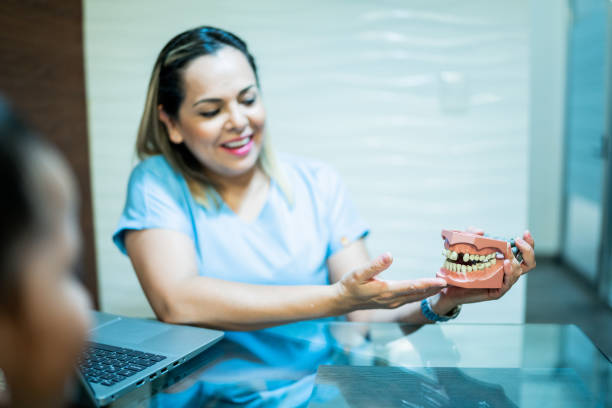 istock Dentist explaining denture to patient at her office 1512040360