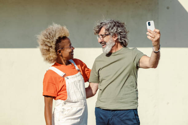 istock Modern good looking people using smart phone and taking selfie in the city 1512111969