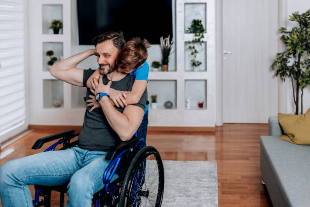 istock Son hugging father in a wheelchair 1512145776