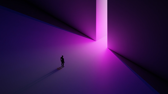 a Man stands in front of the pink light in the gate
