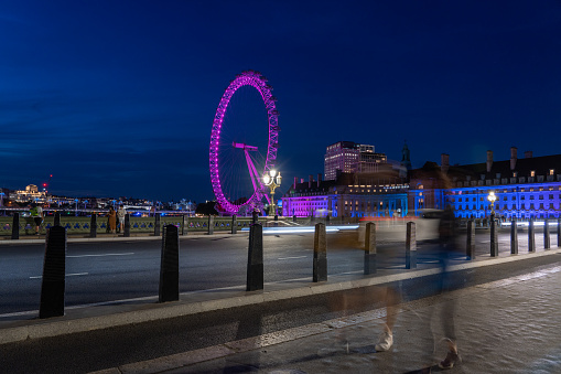 London, UK - July 16, 2022 - Viw of the London Eye at night from the Westminister Bridge