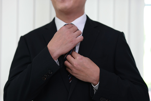 White Collar Worker Adjusting his Necktie, Man straightening necktie.businessman correcting necktie